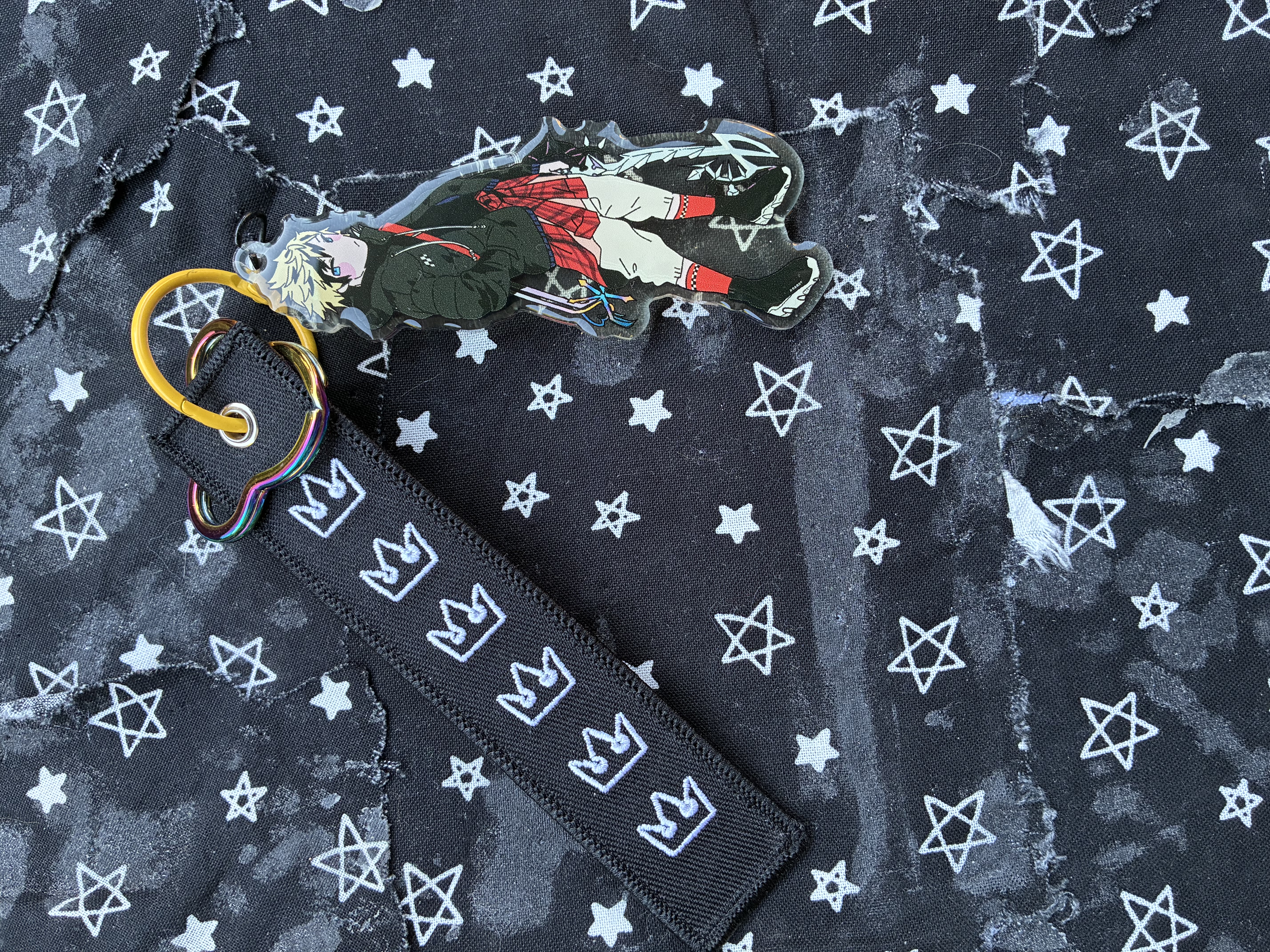 Acrylic charm of Kingdom hearts Roxas in streetwear with oathkeeper on his back, mouse shaped keyring and a crown themed strap.